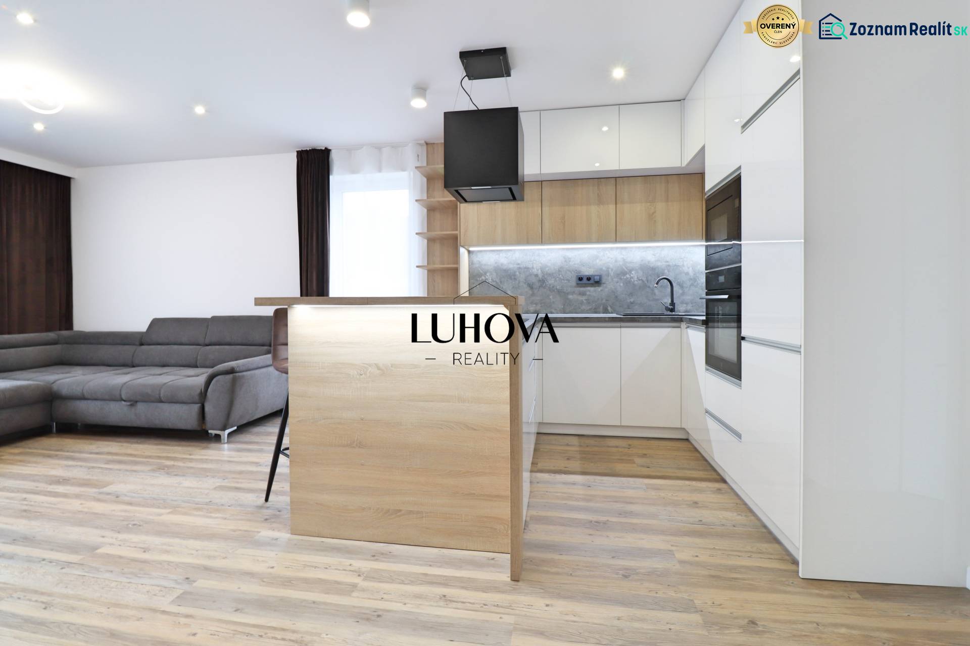 Living room with kitchen and wooden decor flooring in a 3-room apartment.