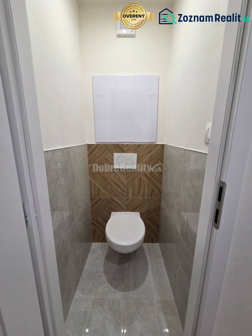 WC with modern tiles and flooring in a 3-room apartment.