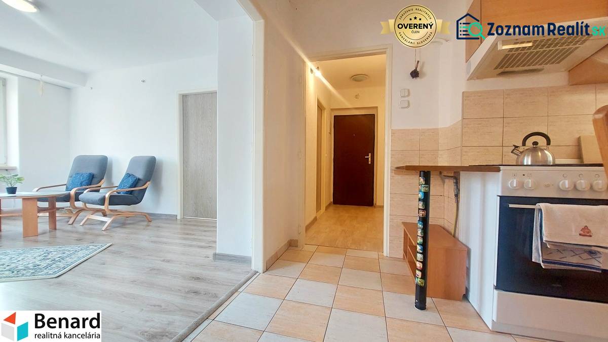 Kitchen with living room, white walls, wood-patterned floor, 2-room apartment.