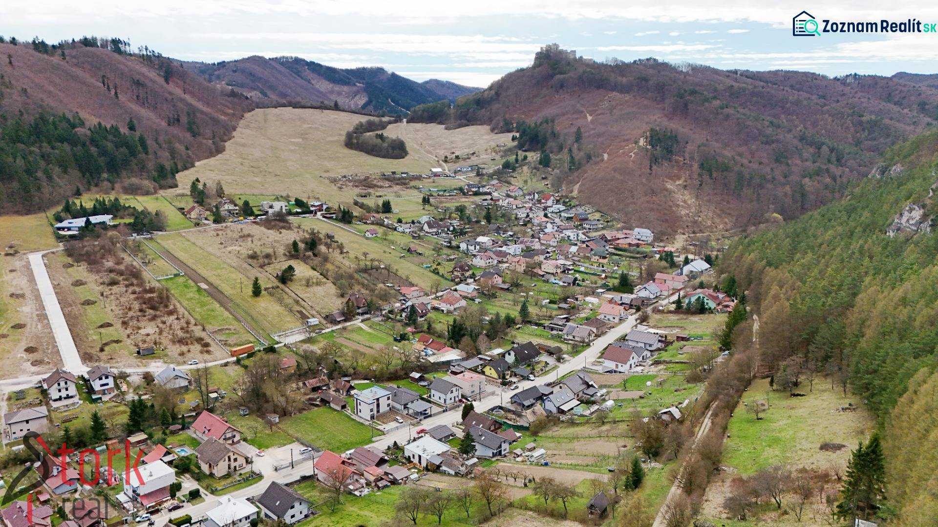 Aerial view of a village surrounded by mountainous landscape in Lietava, on Majer Street, Residential plots.