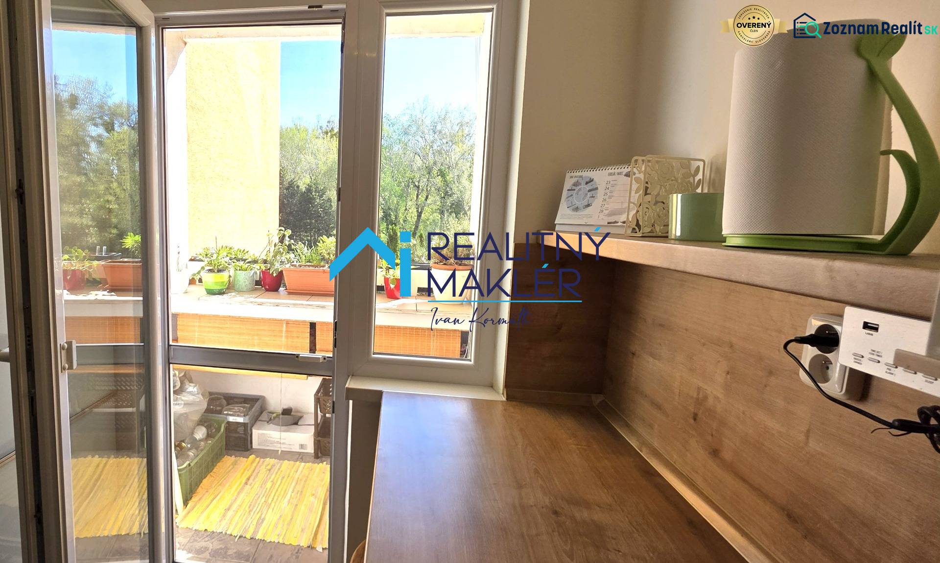 A bedroom with a desk and access to a balcony in a 3-room apartment.