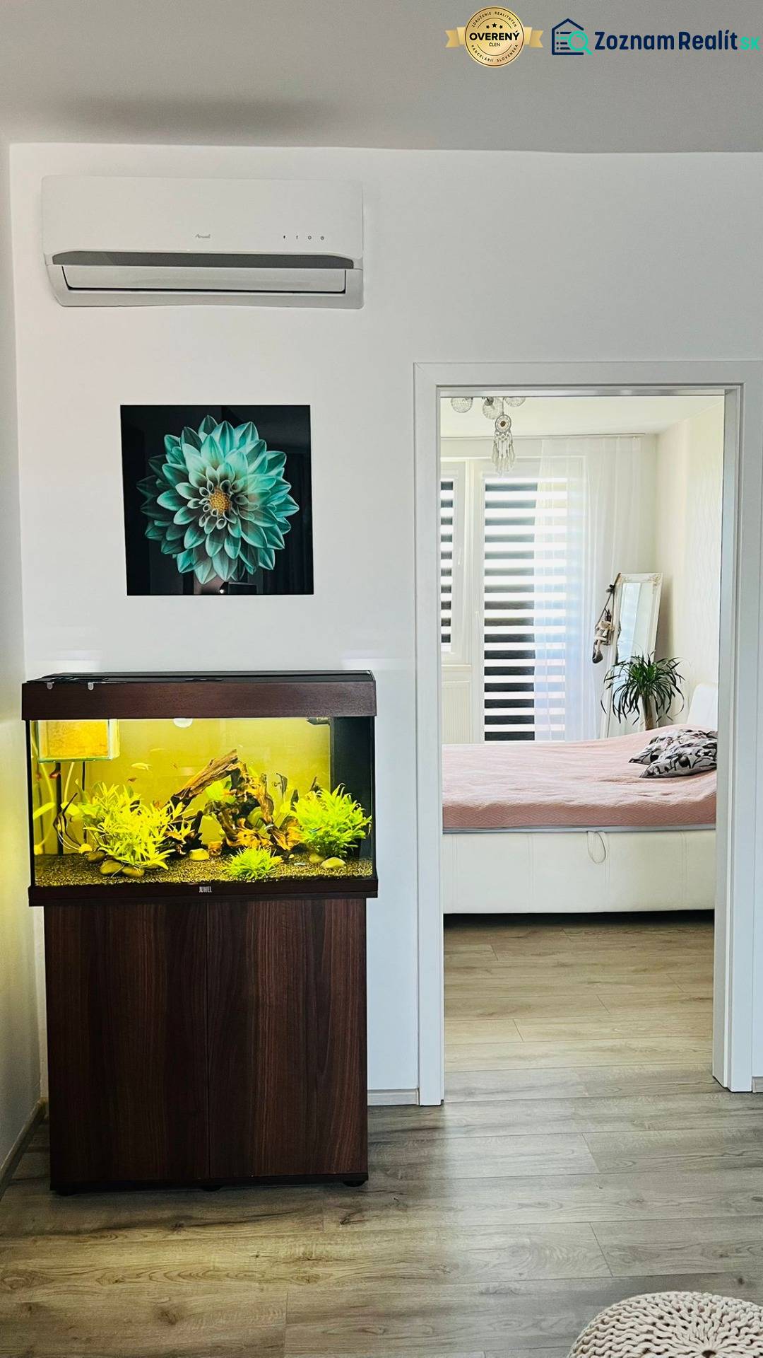Aquarium and wooden decor flooring in a 3-room apartment, transition to a bright bedroom.