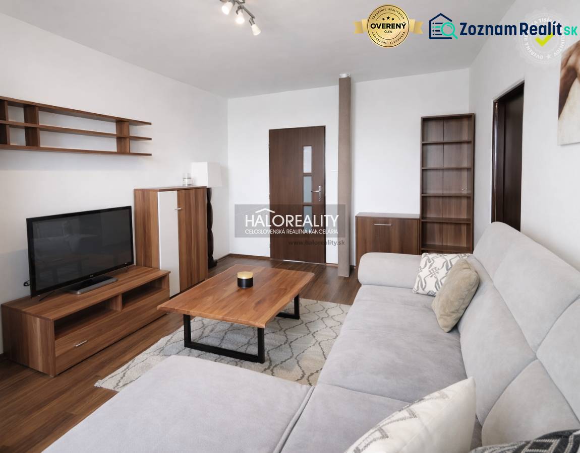 Living room with wood-patterned flooring, a sofa, and a television in a four-room apartment.