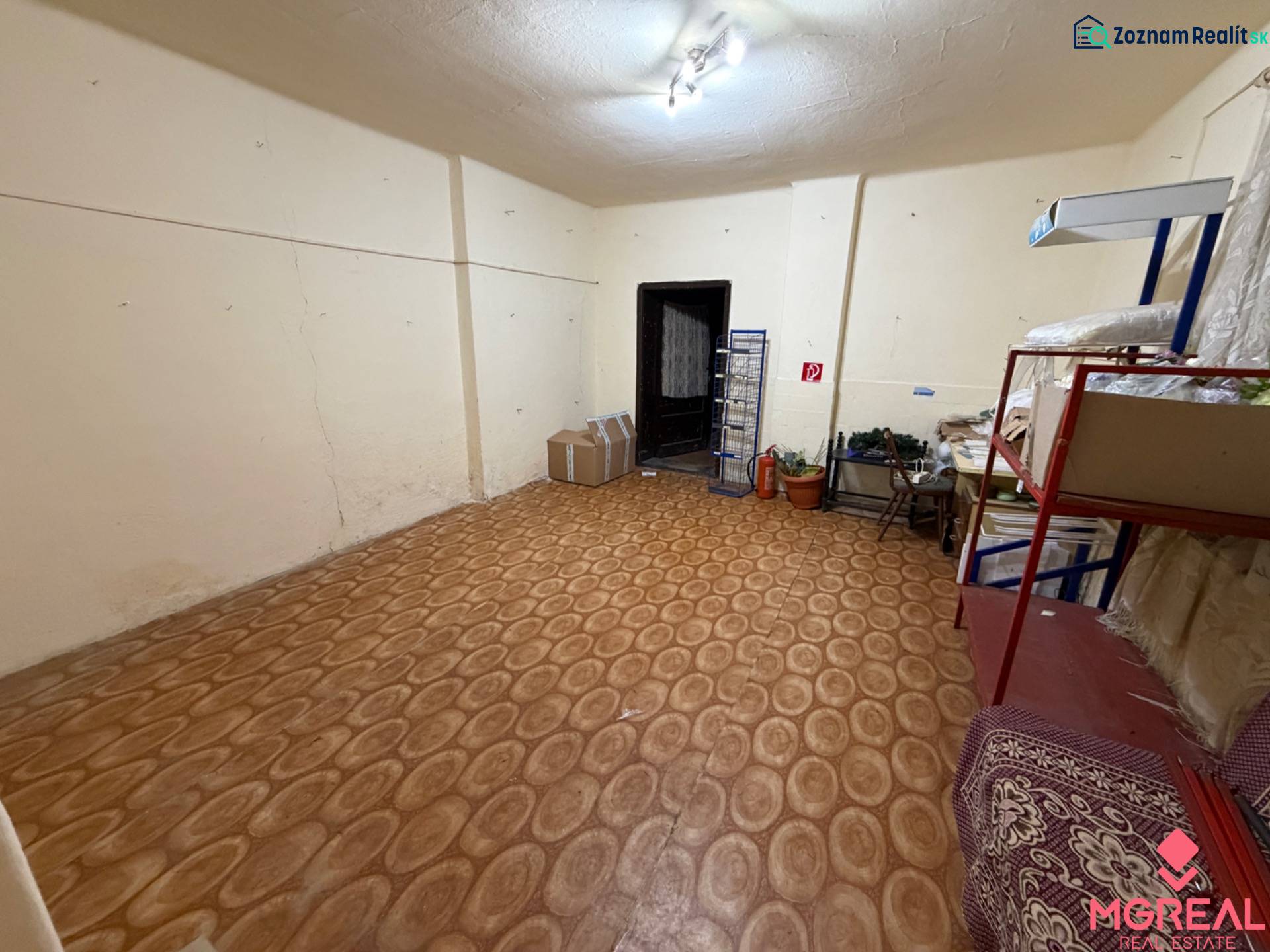 Room in a family house with shelves, boxes, and a wooden decor floor.
