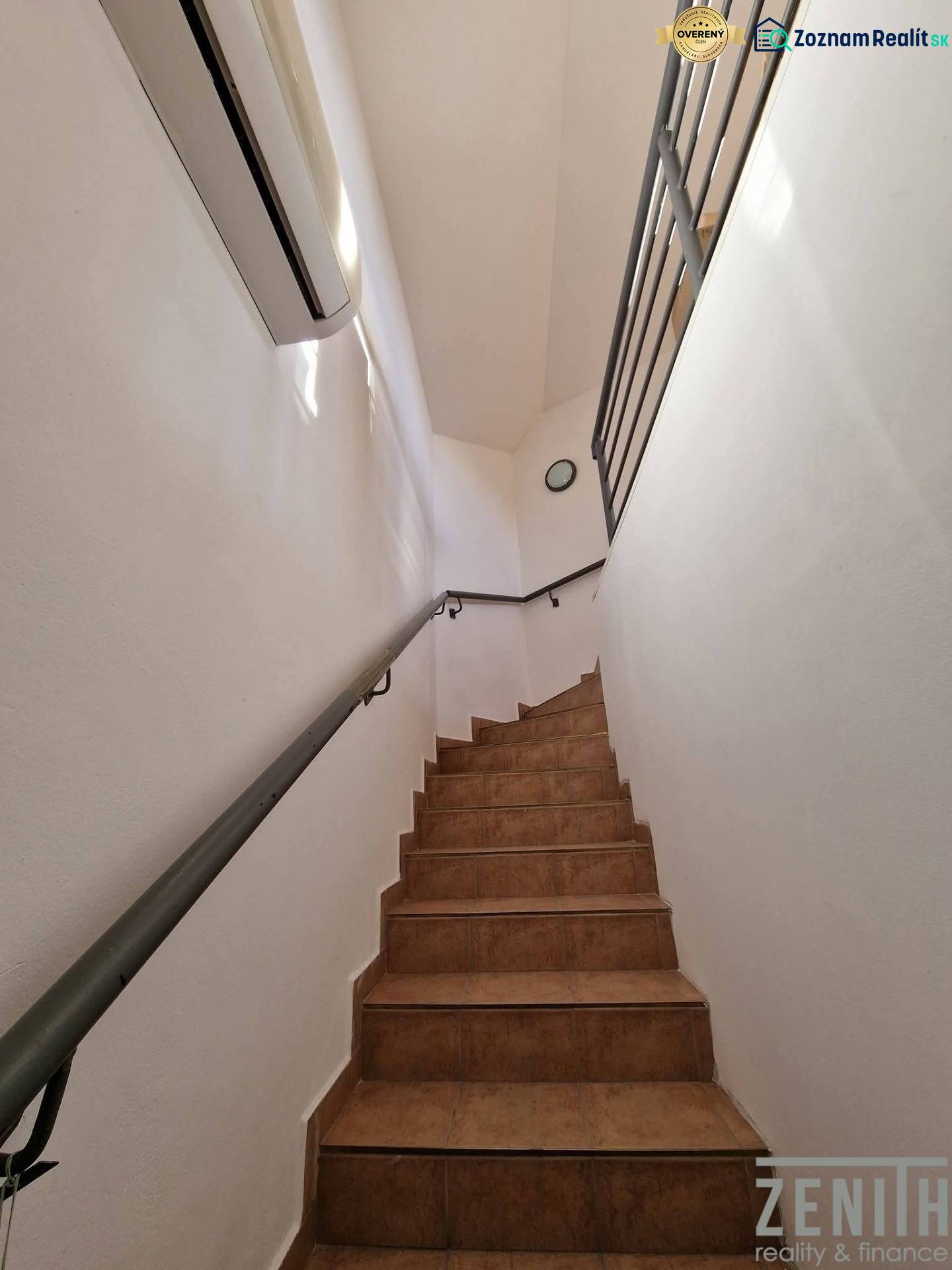 Interior of commercial premises with ceramic stairs and white walls.