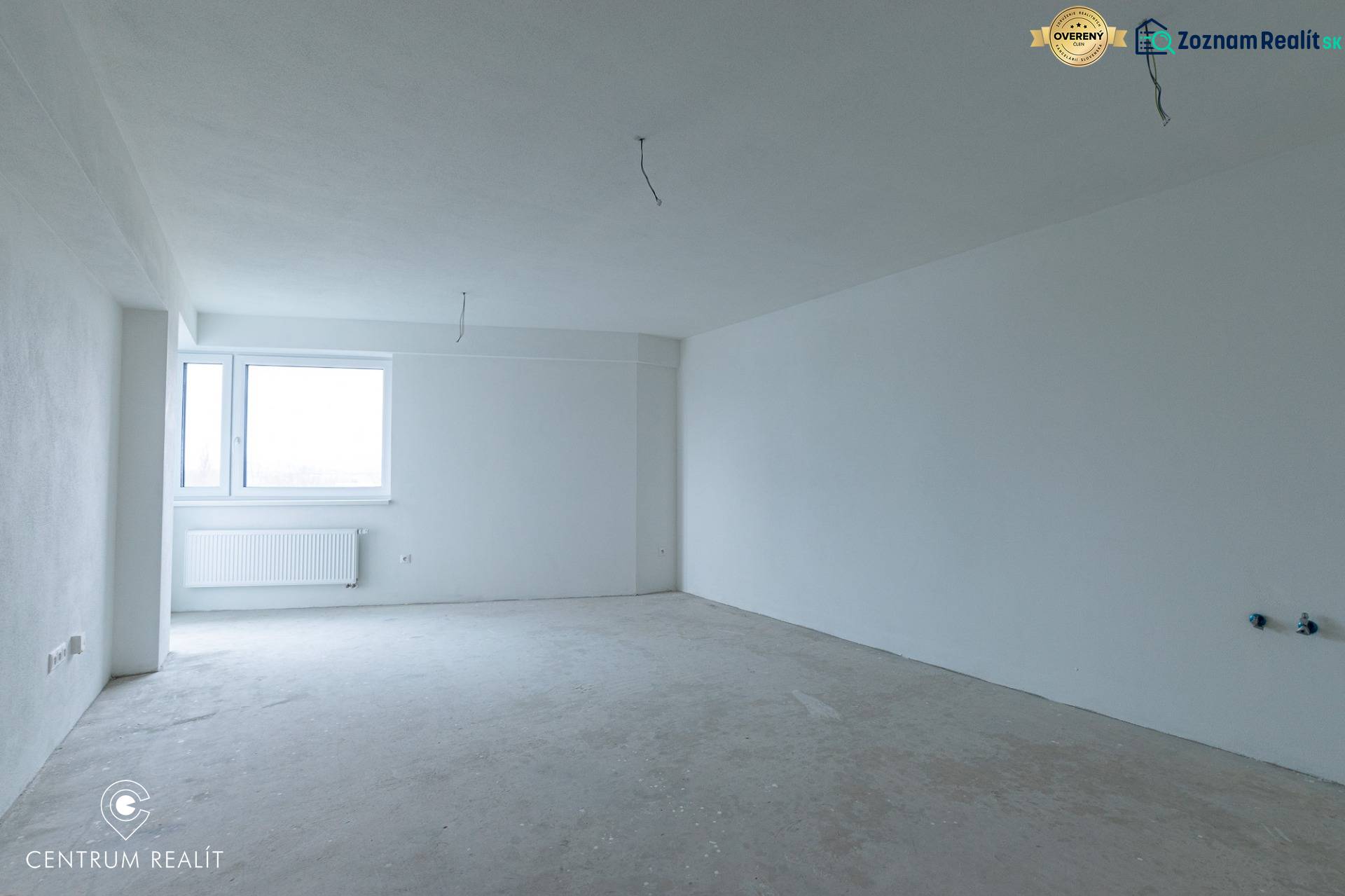 Empty room in a two-room apartment with a window and white walls without furniture.