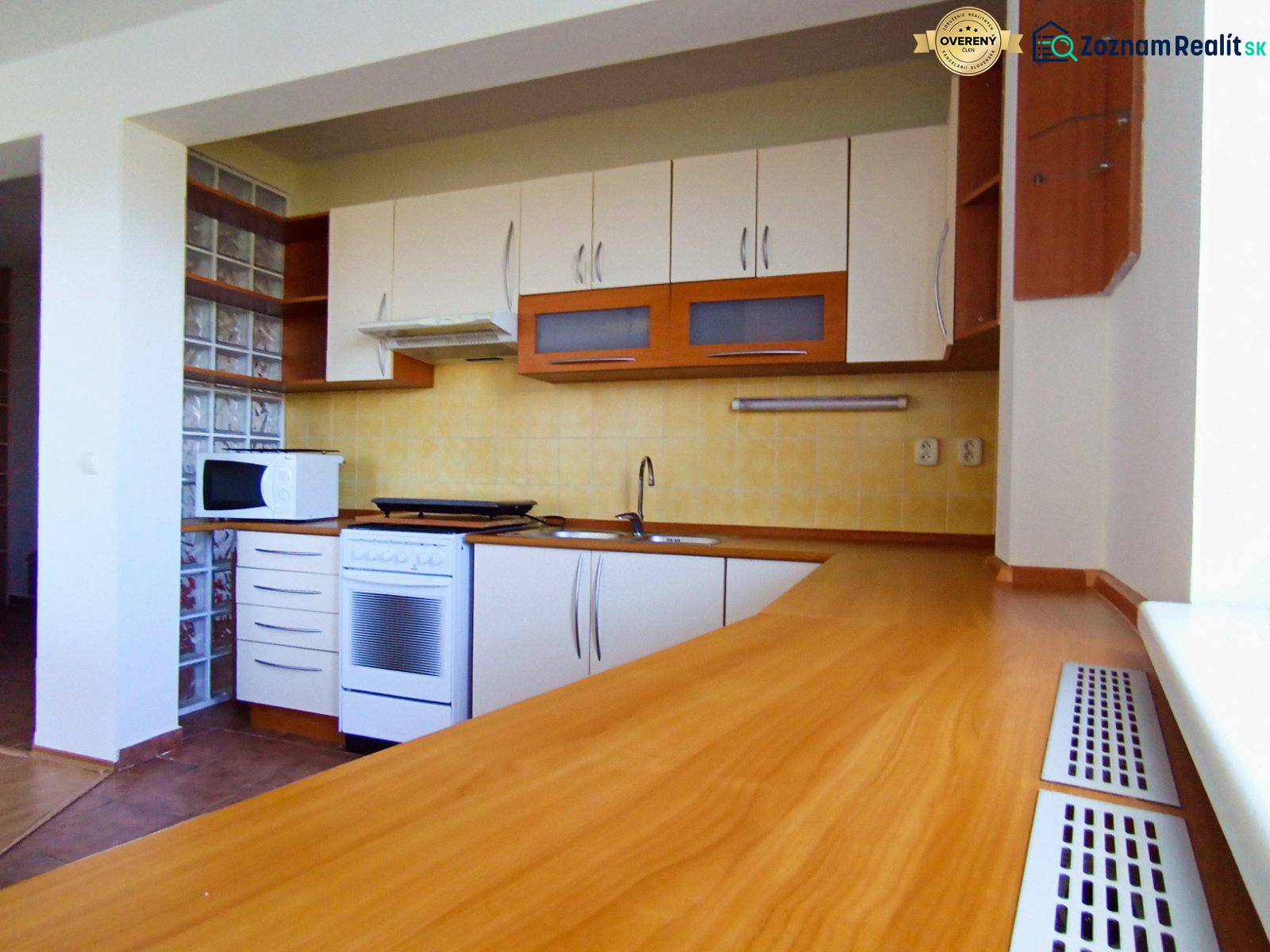 Kitchen in a 3-room apartment, front view, kitchen unit with wooden decor.