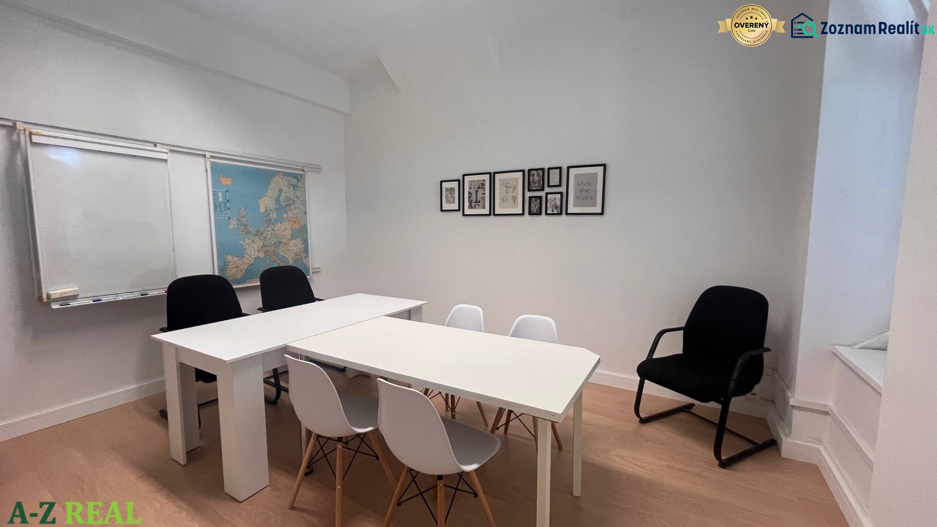 An office with white furniture, a map of Europe on the wall, and a floor with a wooden decor.