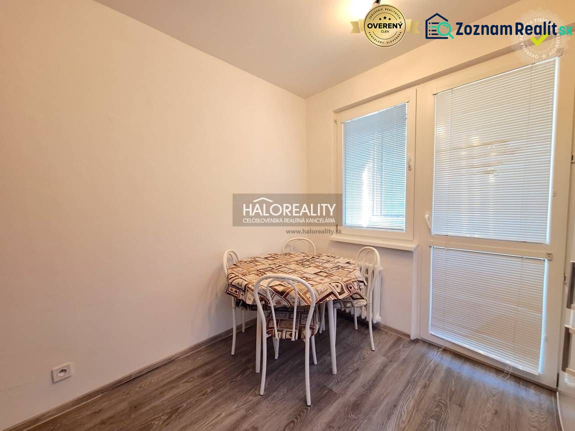 Dining area with a table, chairs, and flooring with a wooden decor in a 4-room apartment.