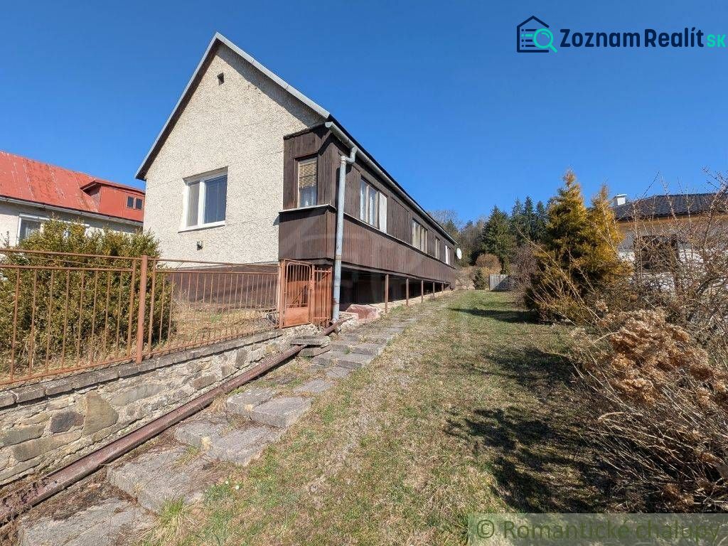 A family house in Kalinovo with concrete stairs and wooden railing on a slope.