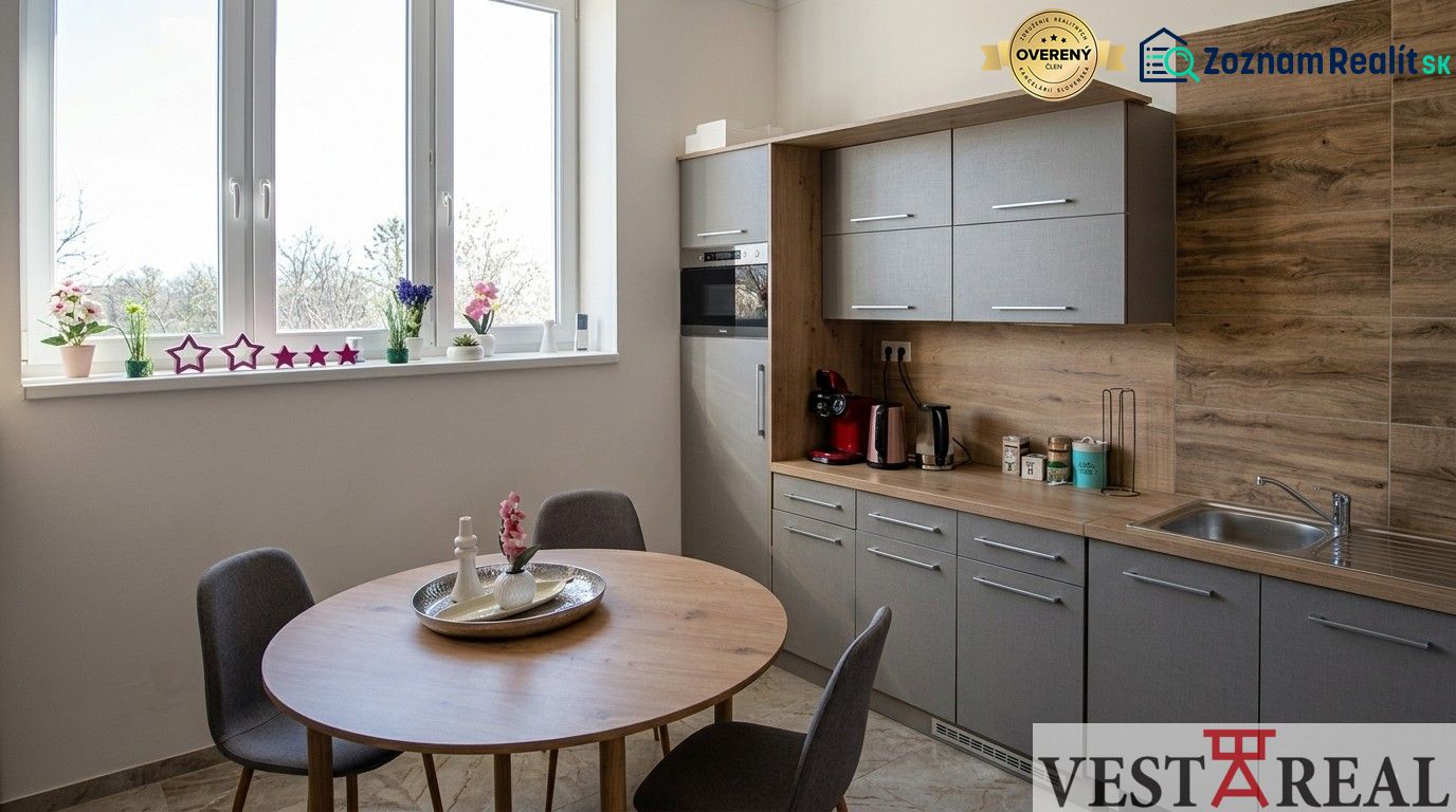 Kitchen corner in offices with a window, wooden decor, and a dining table.