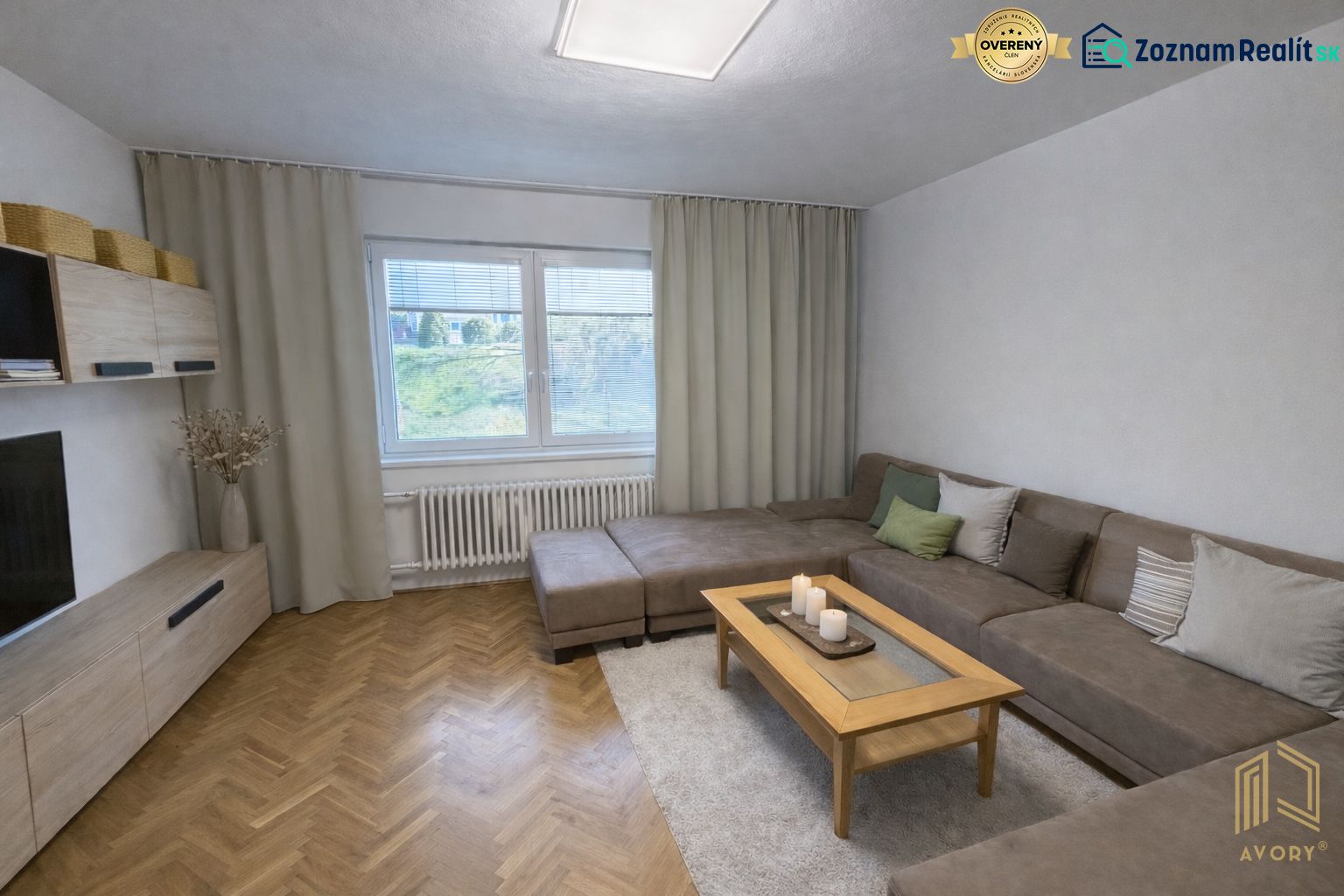Living room with a sofa and wooden floor decor in a family house.