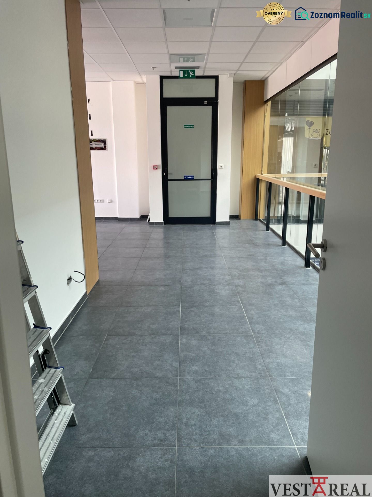 Commercial spaces with tiles and glass, suitable for various purposes.