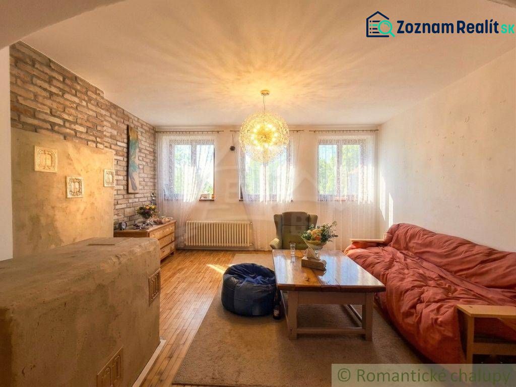Living room in a family house with a brick wall and a wooden decor floor.