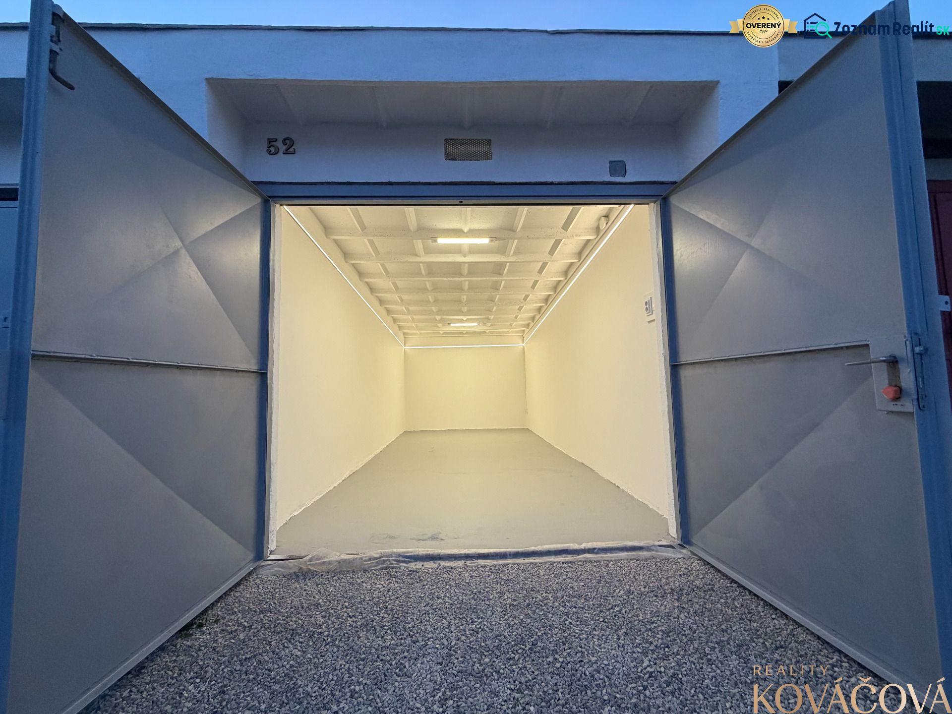 Open garage on Bezručova Street in Trenčín with a white interior and gravel surface.