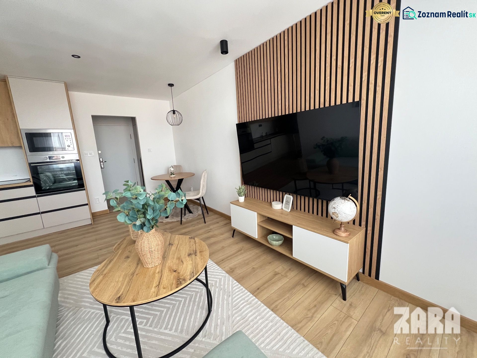 Living room in a two-room apartment with wood decor and minimalist furniture.