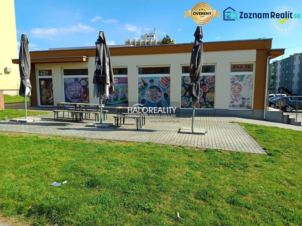 The exterior of commercial premises in Žiar nad Hronom with a terrace and retracted umbrellas.