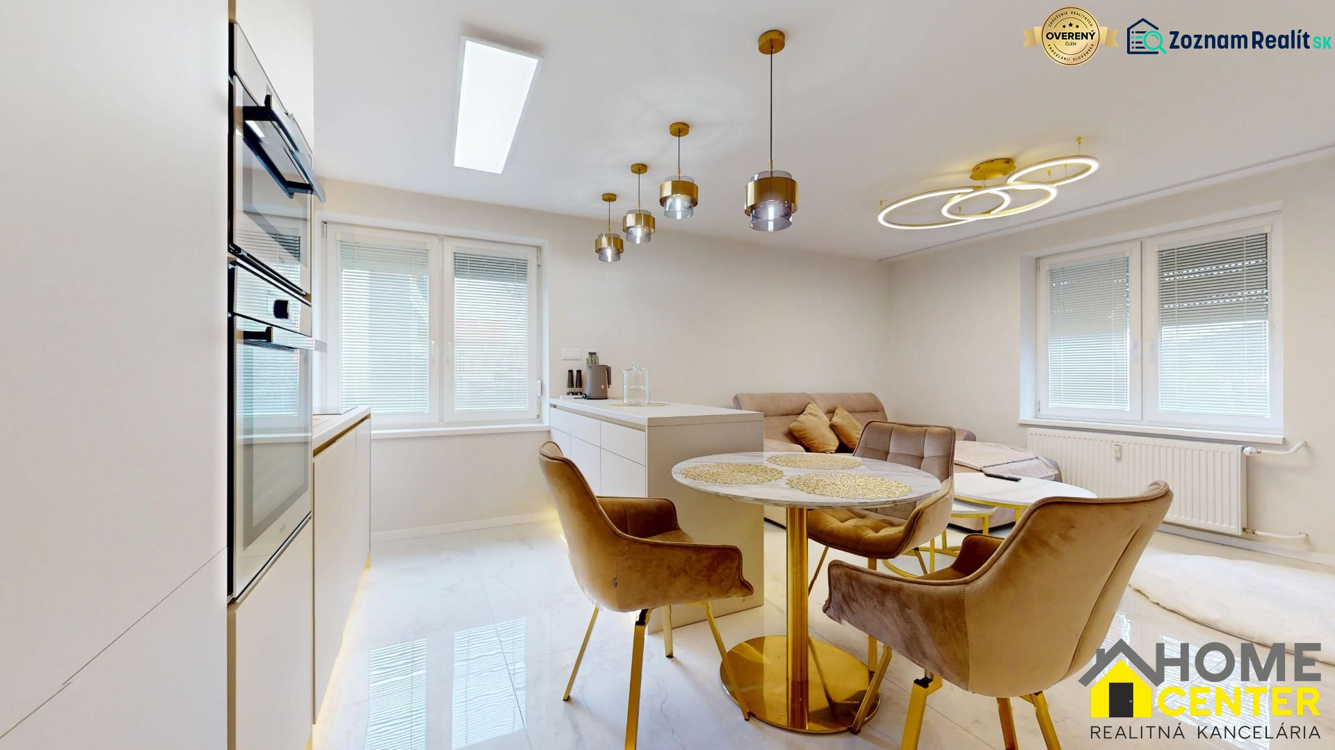 A dining nook with golden details and comfortable chairs in a 3-room apartment.