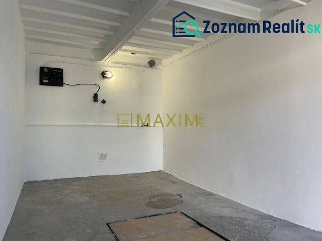 An empty interior with white walls and a concrete floor in a garage on Astronomická Street, Bratislava - Ružinov.