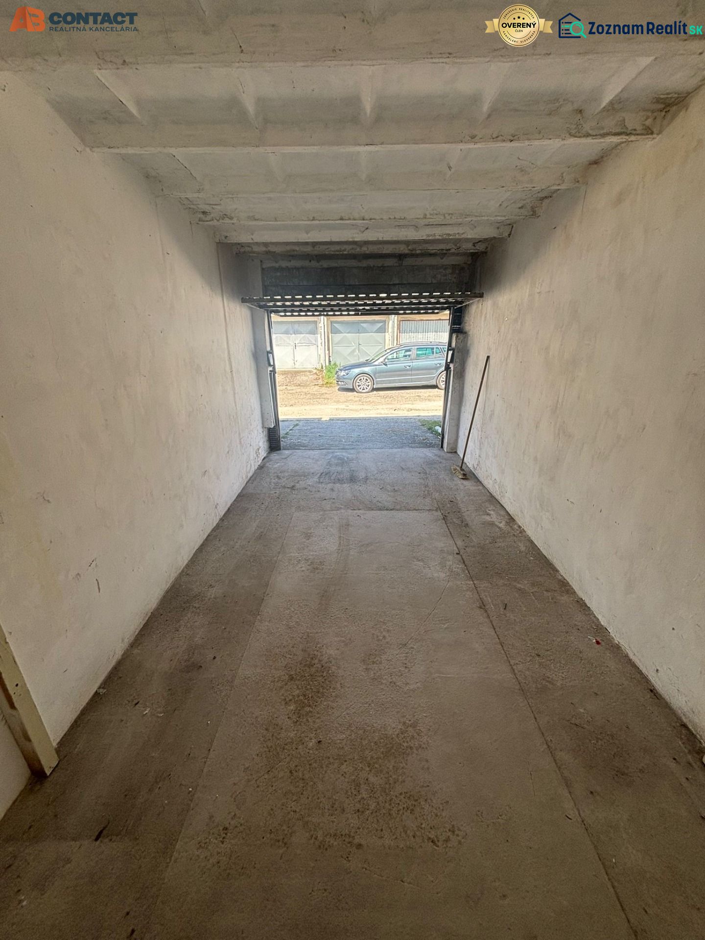A garage with open doors on Dopravná Street in Piešťany, concrete floor.