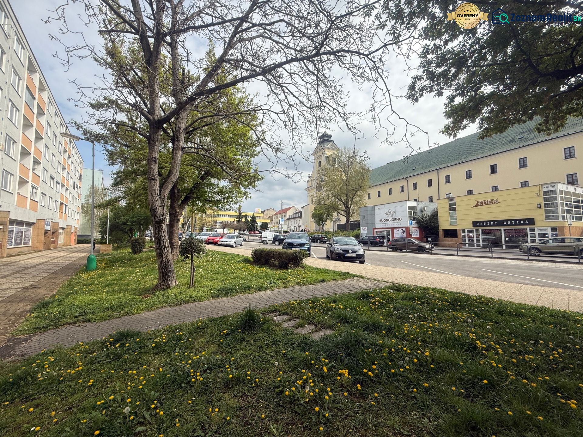 Commercial premises on A. Hlinku Street in Prievidza with a building and cars.