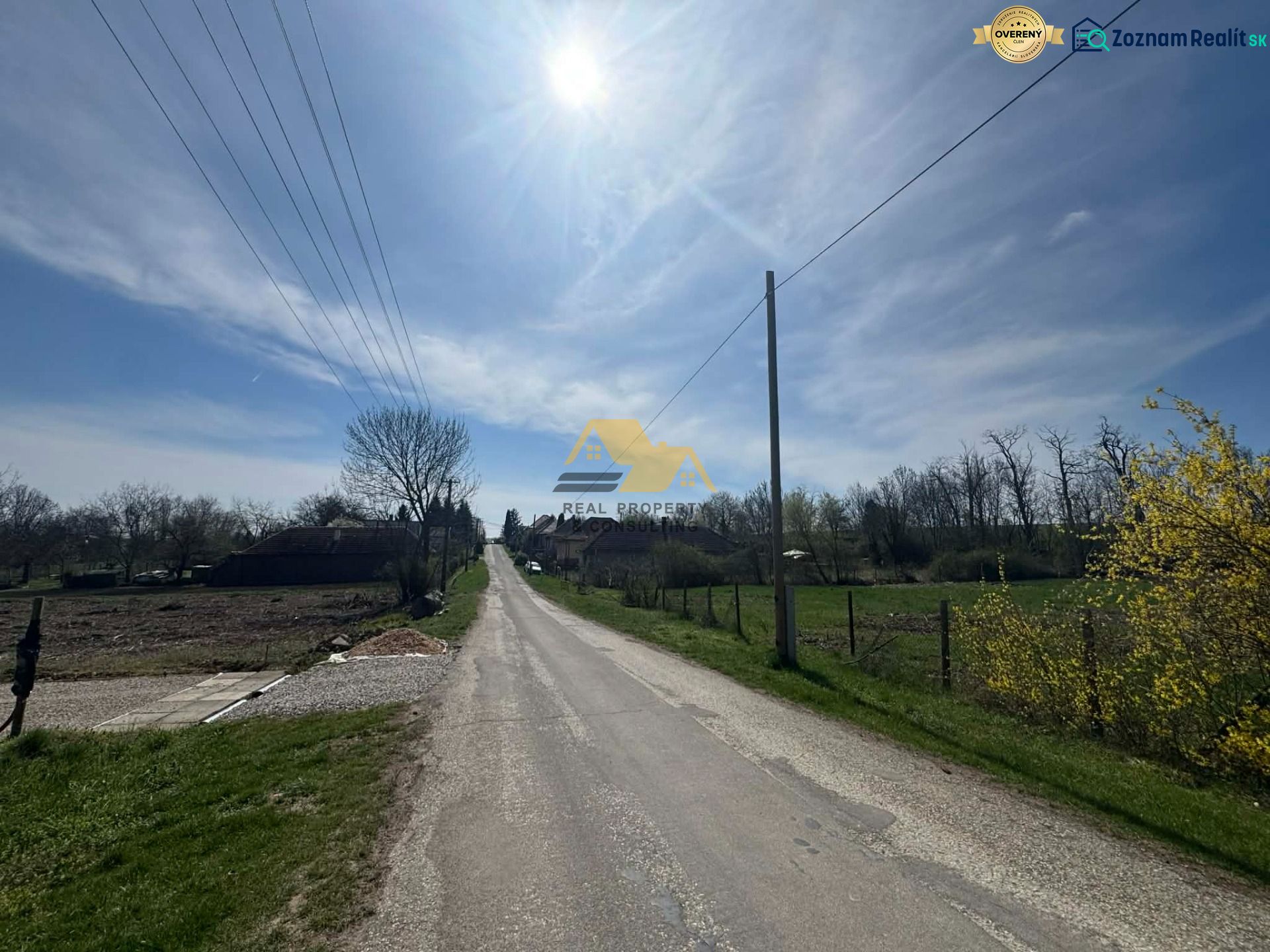 A rural road in Bardoňovo with plots - living surrounded by nature and trees.
