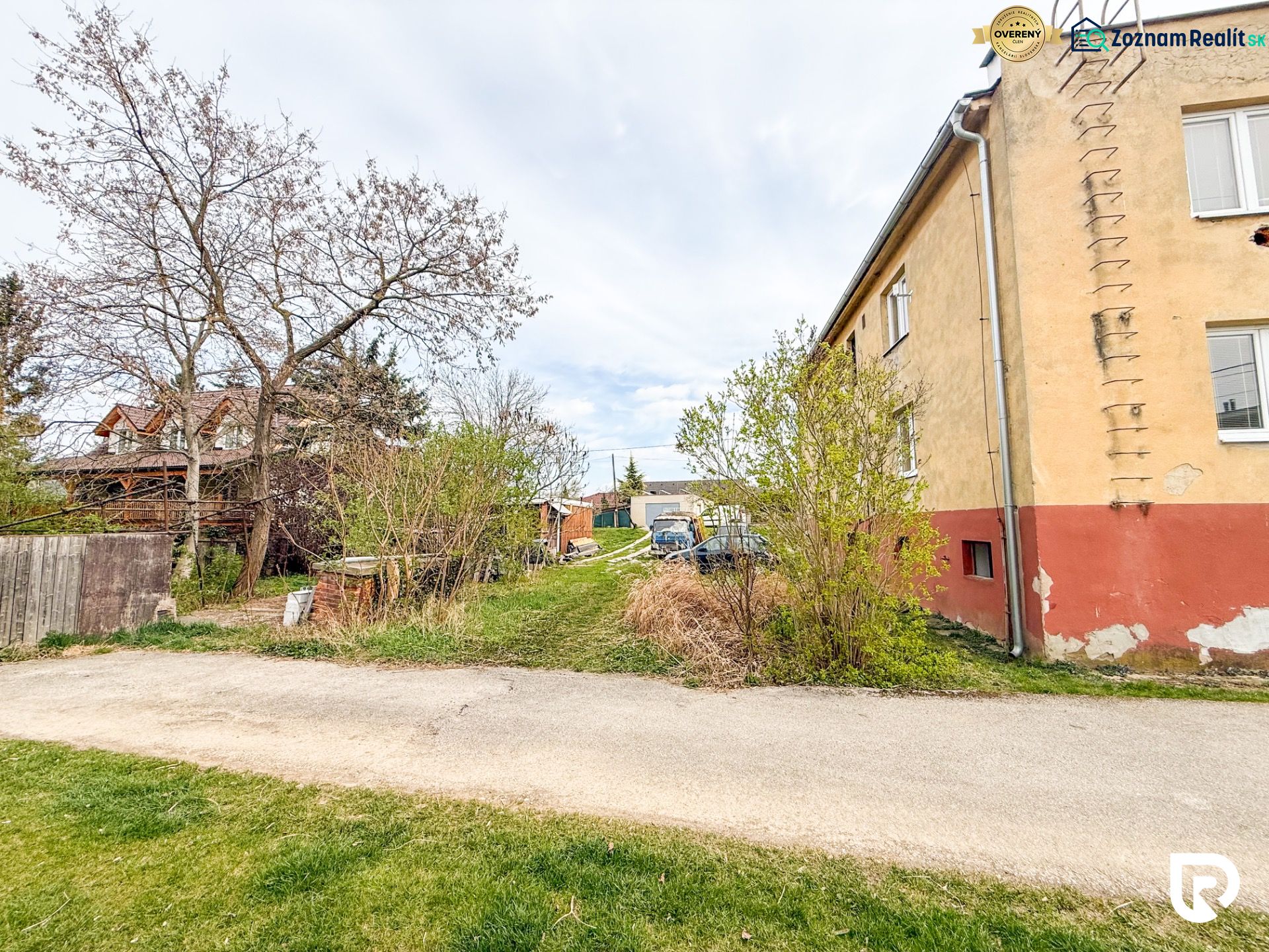 Hrabovská Street in Trenčín, the road runs alongside an older house with a garden.