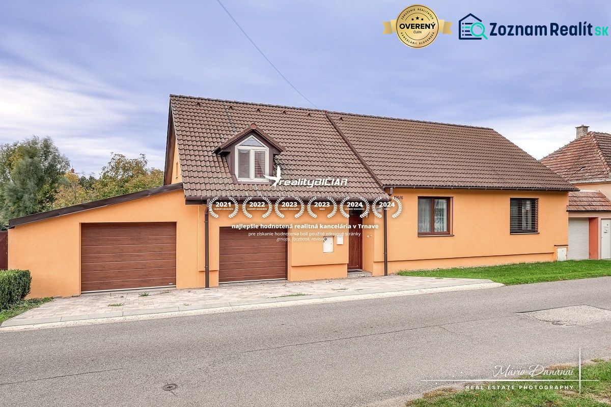A family house on Špačince Street in Špačince with a pitched roof and a garage.