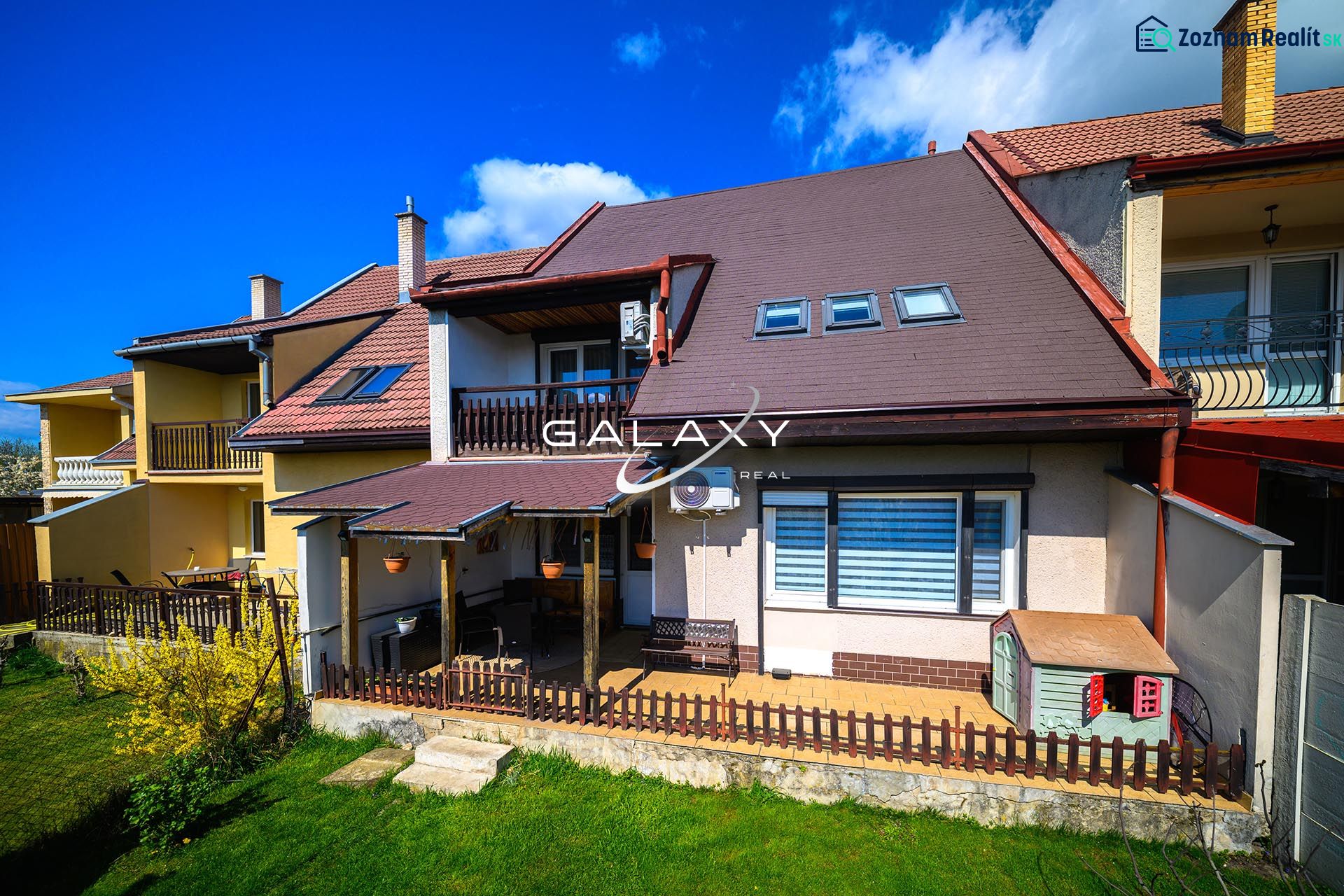 A family house in Rimavská Sobota with a sloped roof and a grassy garden.