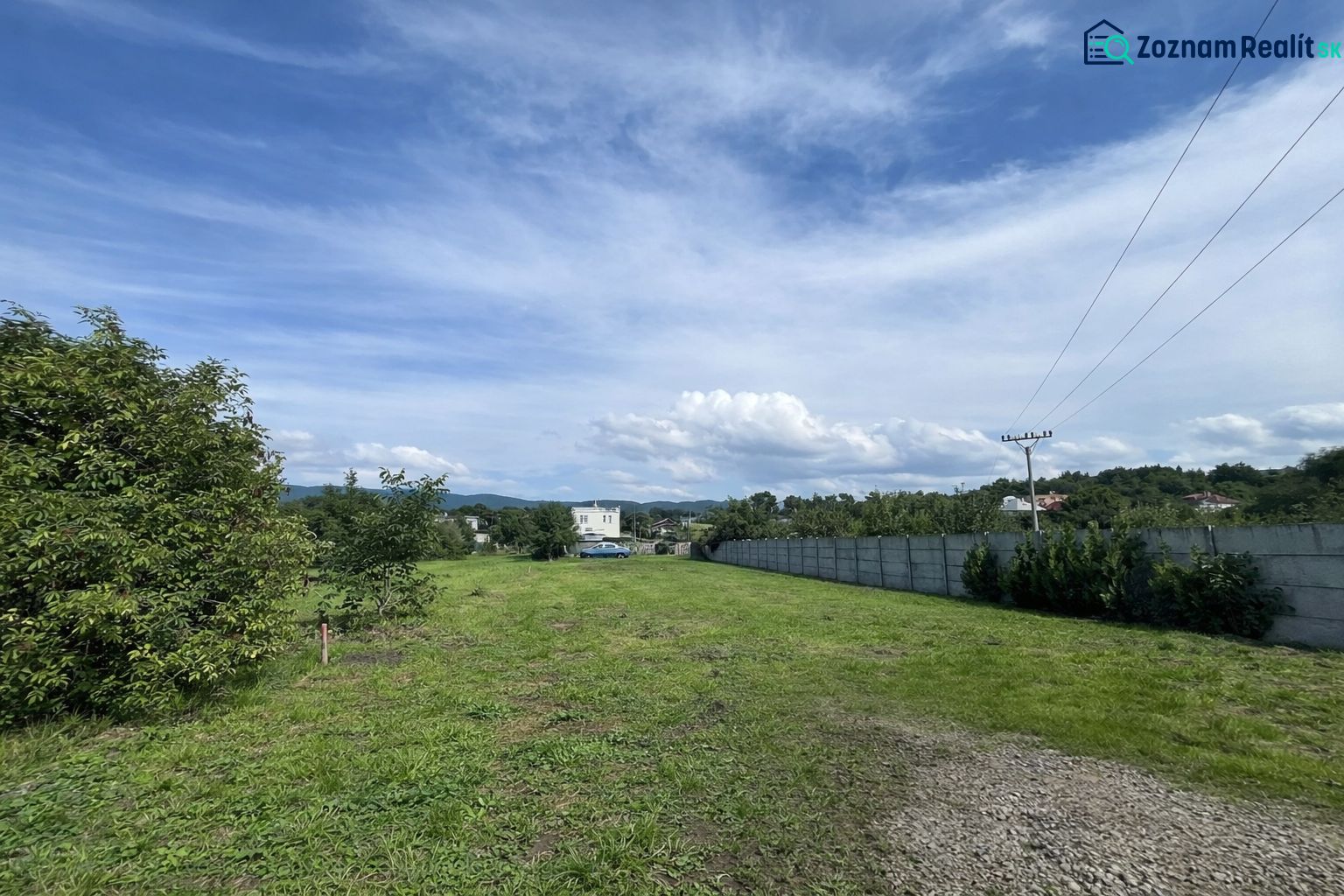 Plots - housing on Ábovská Street in Ždaňa, green area with power lines.