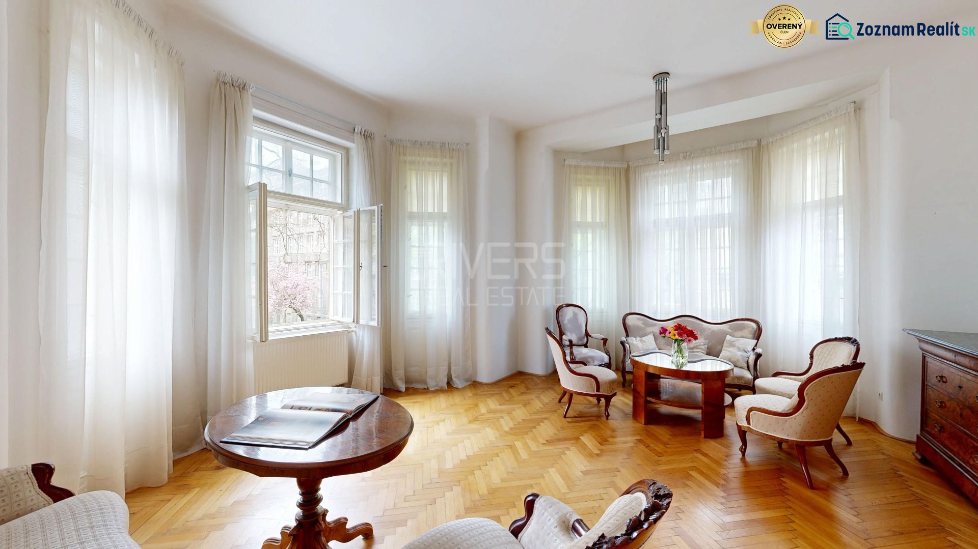 A bright living room with historical furniture and a wooden decor floor in a 4-room apartment.