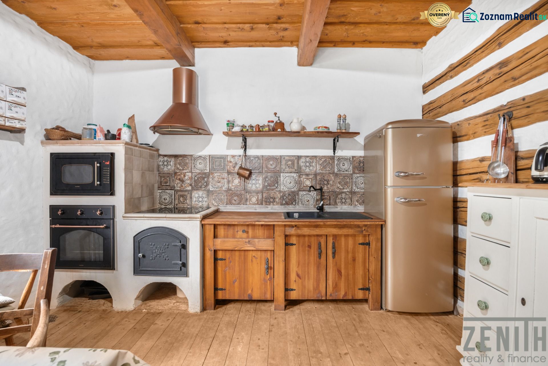 Interior of a family house with a kitchenette, oven, wooden furniture, and a floor with a wooden decor.