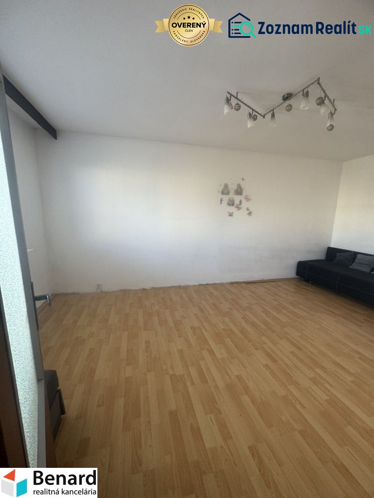 Installed lighting, sofa, and wood-patterned flooring in a 3-room apartment.