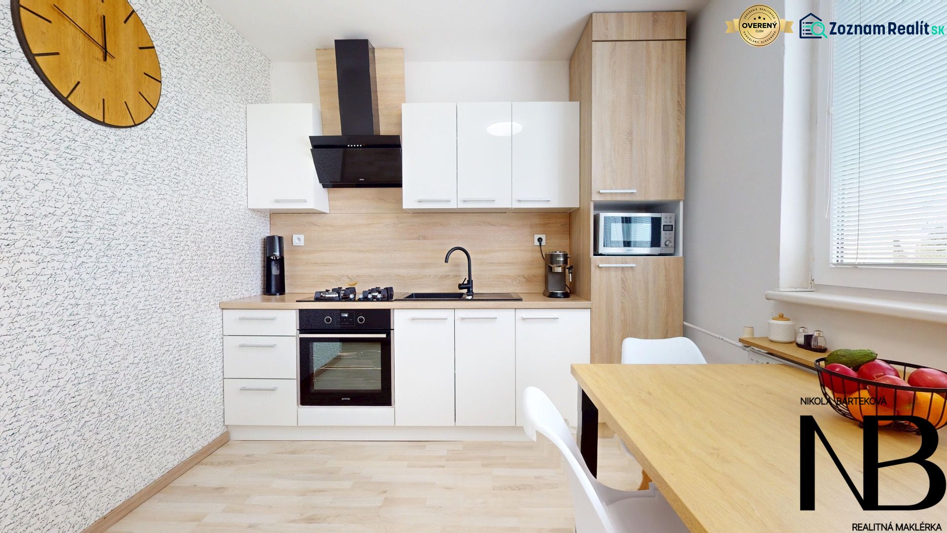 A kitchen in a 3-room apartment with modern furniture and a wooden decor floor.