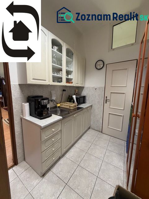 Offices with a coffee machine and white cabinets, tiles, next to the kitchen.