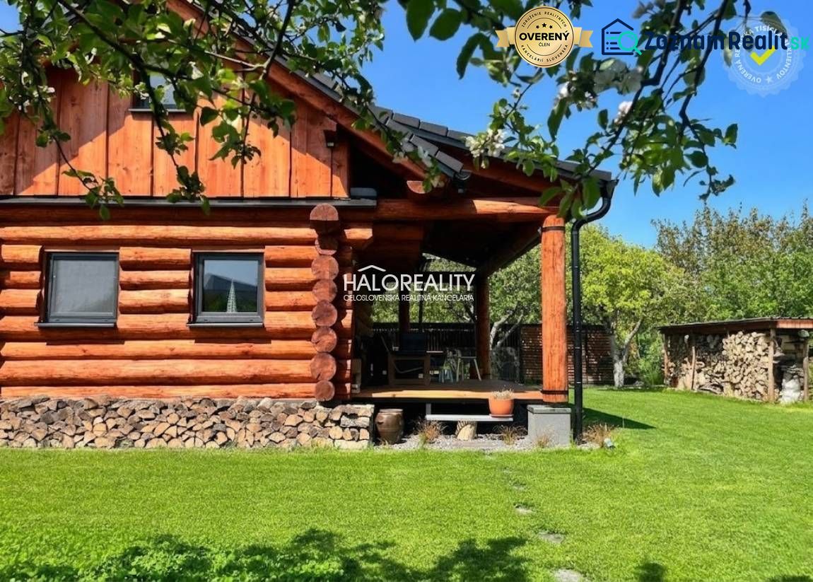 A wooden cottage surrounded by greenery in Piešťany with a well-maintained lawn and firewood.