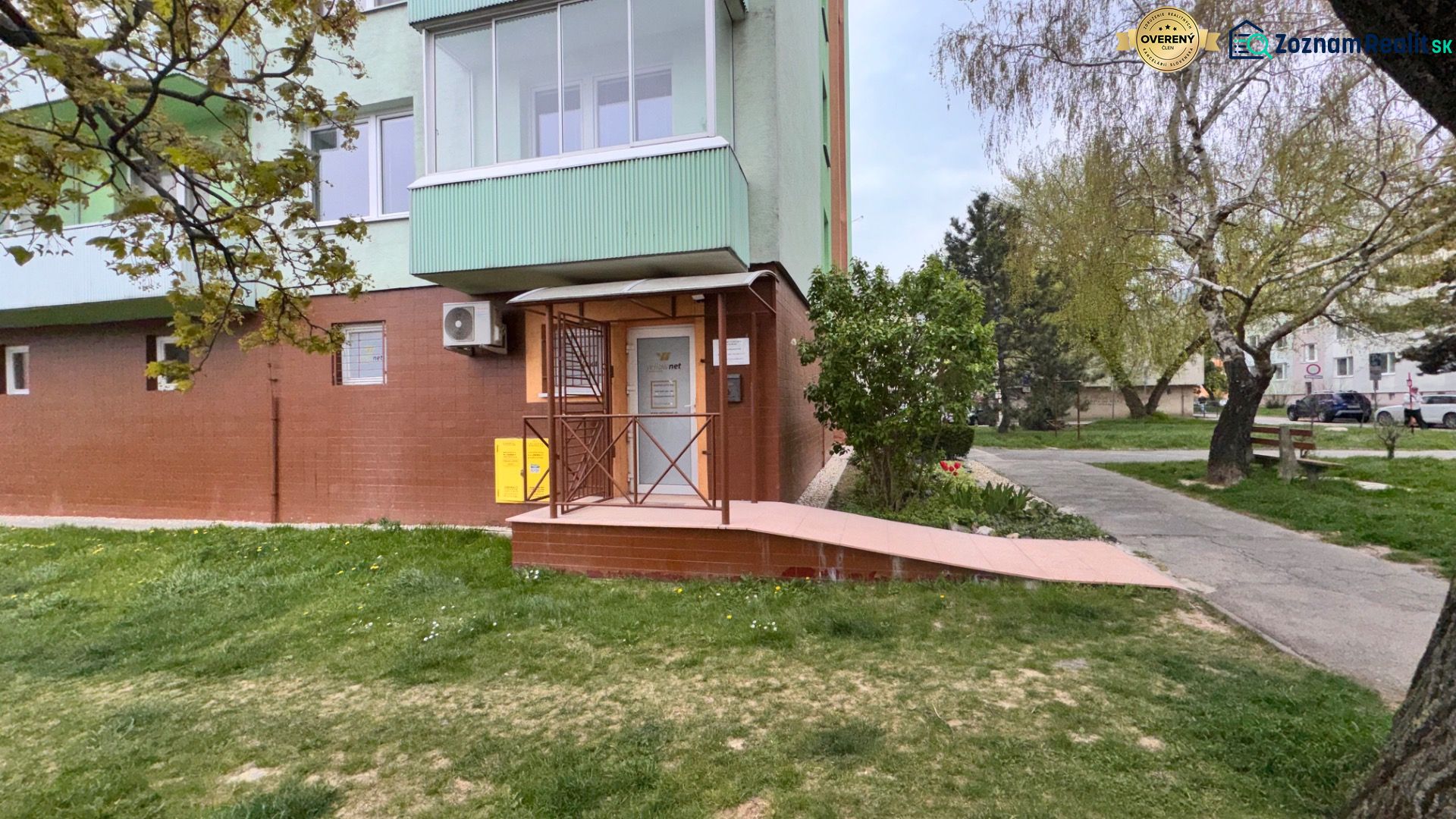 Exterior of commercial premises on Robotnícka Street in Senica with a sidewalk and greenery.