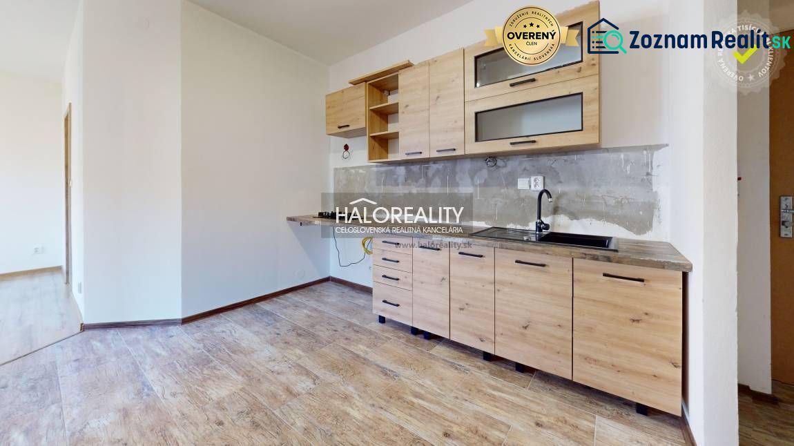 Studio apartment with a kitchenette and a wooden decor floor.