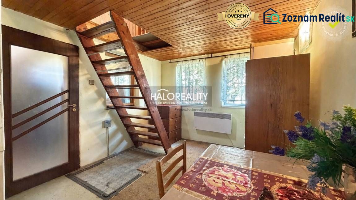 Interior with staircase, wooden ceiling, and floral decoration in the Gardens.