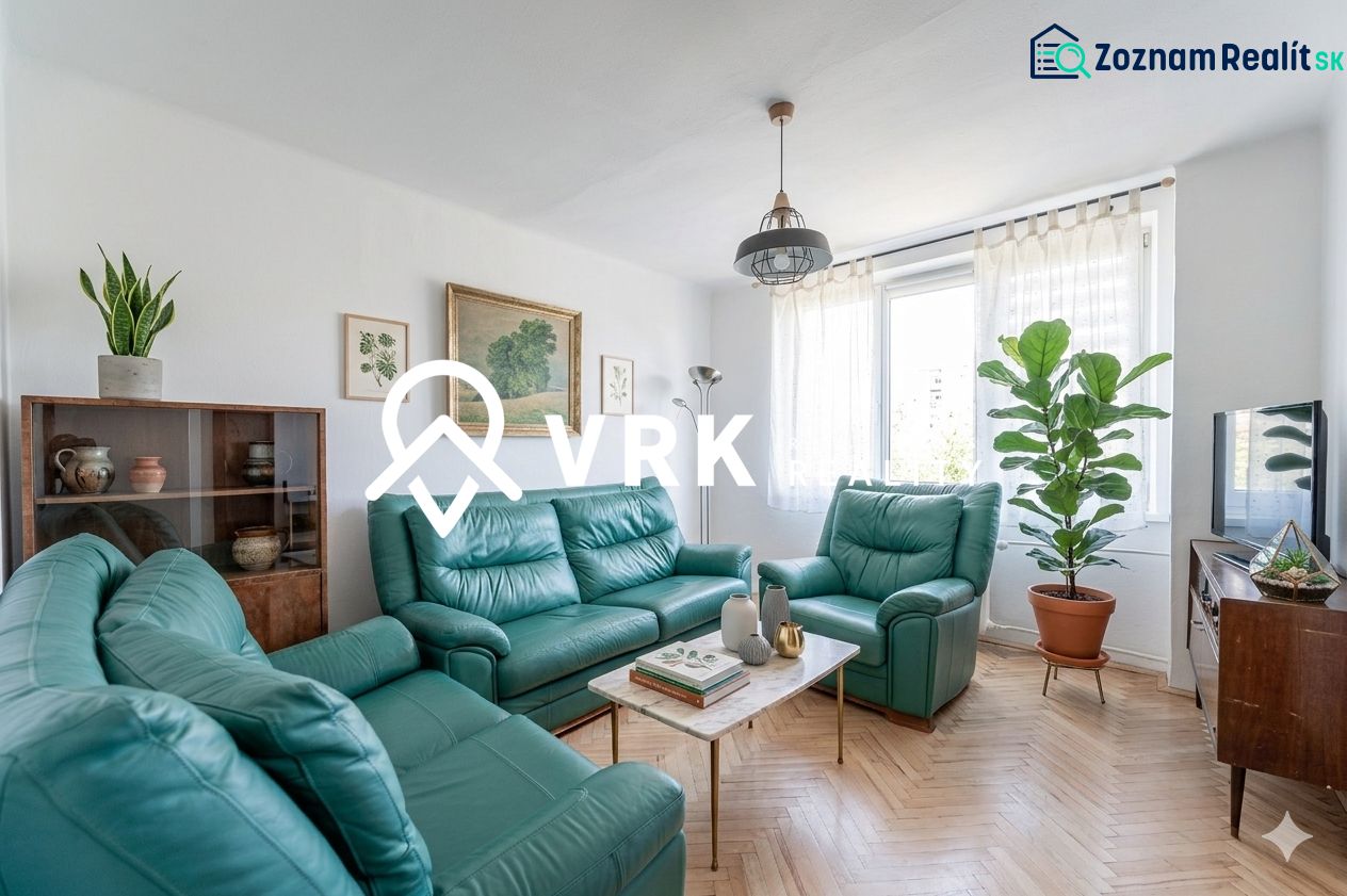 Living room in a two-room apartment with sofas, plants, and a wooden decor floor.