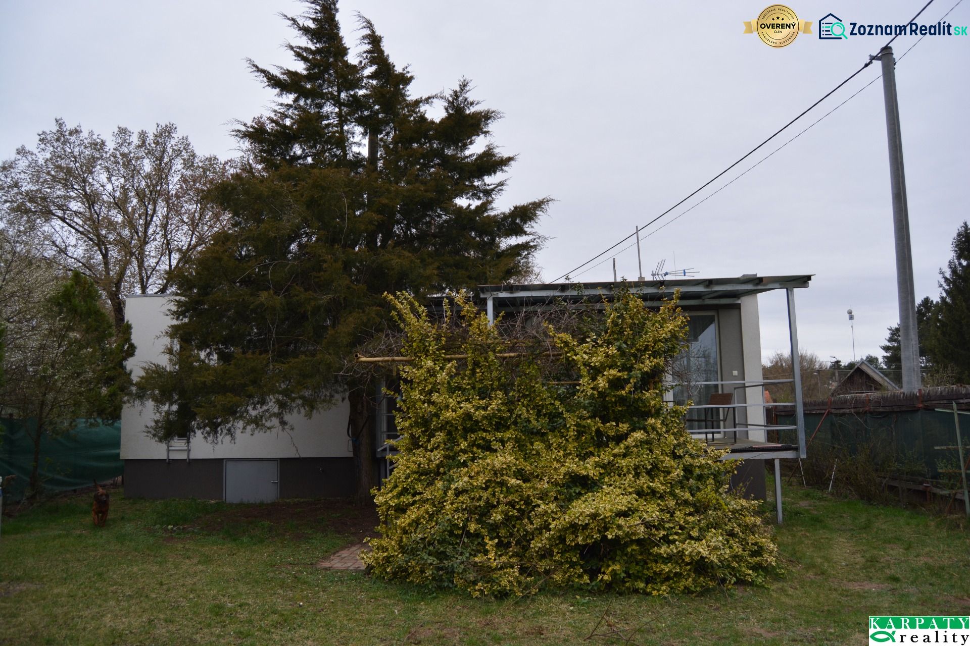 A family house on Húšky Street in Borský Svätý Jur surrounded by greenery and trees.