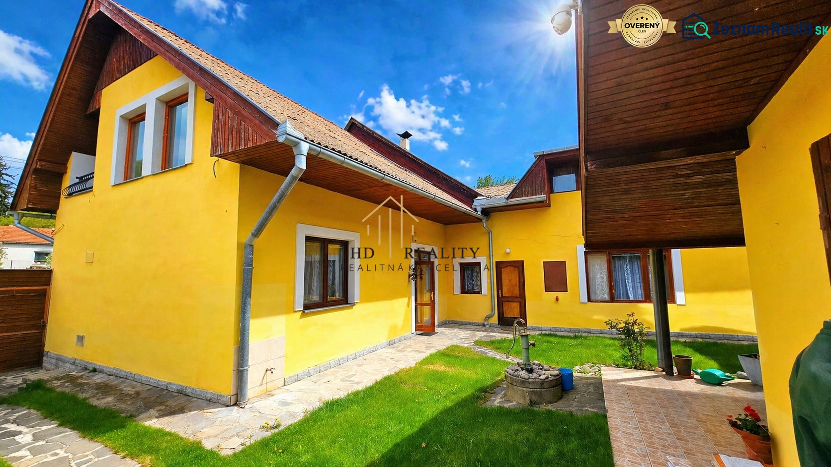 A family house on E. M. Šoltésová Street in Lučenec with a yellow facade and a green lawn.