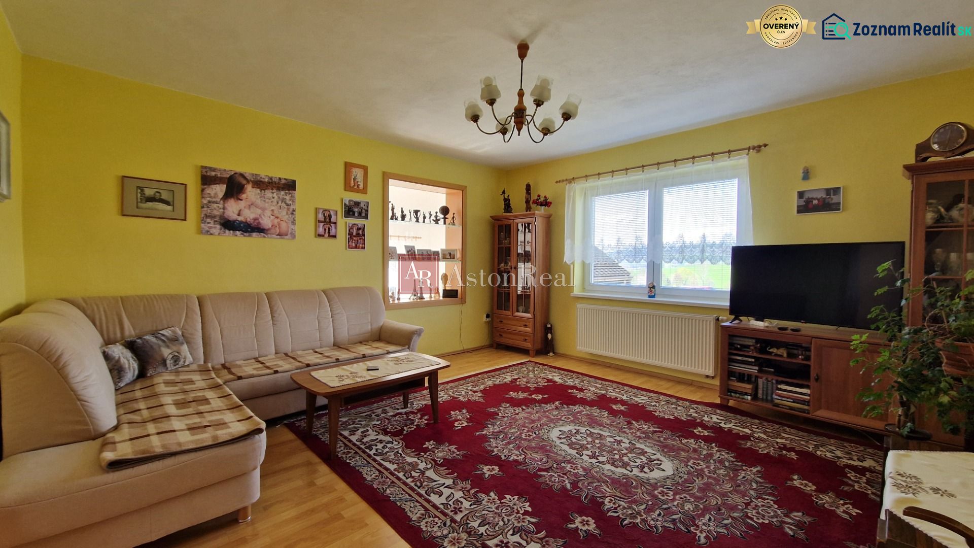 Living room in a family house with a comfortable sofa and a decorative carpet.