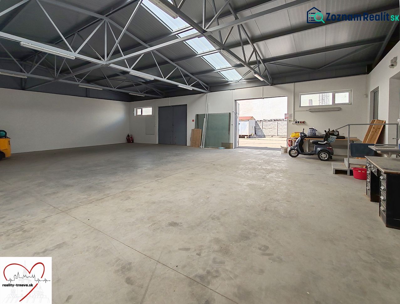 Interiors of warehouses and halls with concrete floors, skylights, and open doors.