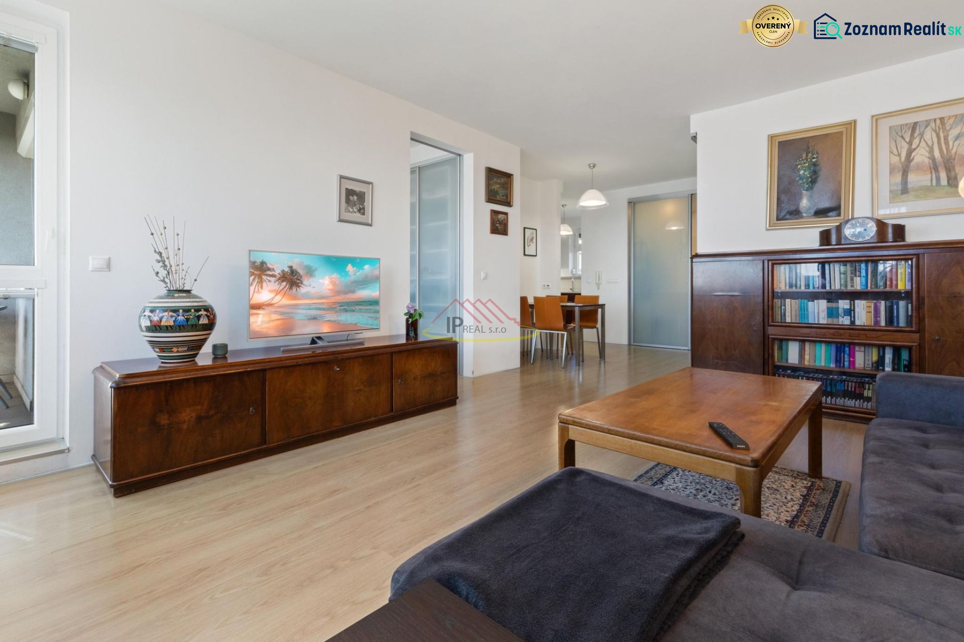 Living room with a sofa set, a table, and a wooden decor floor in a 2-room apartment.