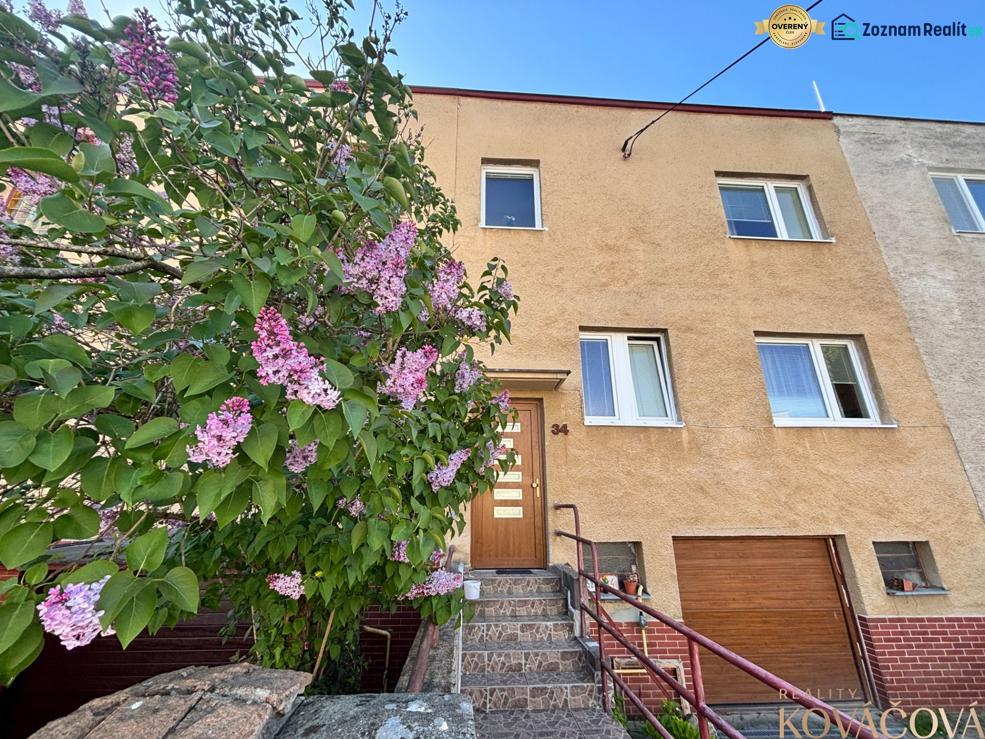 A family house on Hurbanova Street in Trenčín with entrance stairs and blooming lilac.