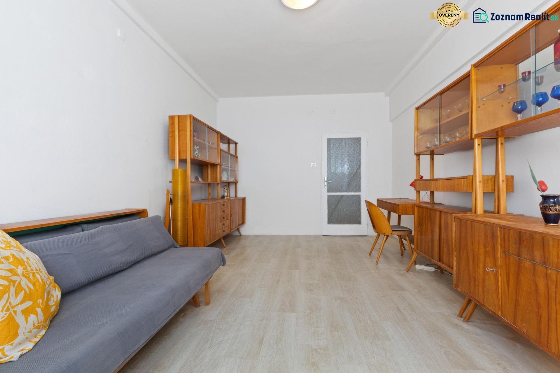 Interior of a 3-room apartment with retro furniture and wooden decor flooring.