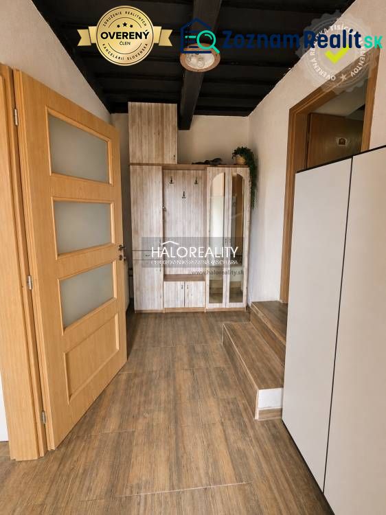 A hallway with stairs and a wooden decor floor in a family house.