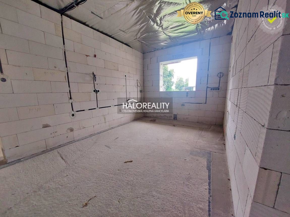 A room in a family house with raw walls, ready for completion.