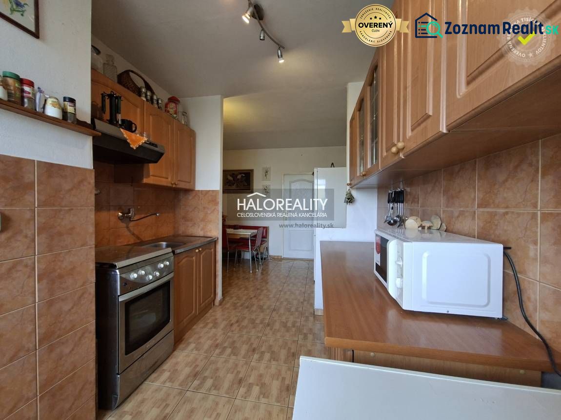A kitchen in a 3-room apartment with wooden decor and appliances.